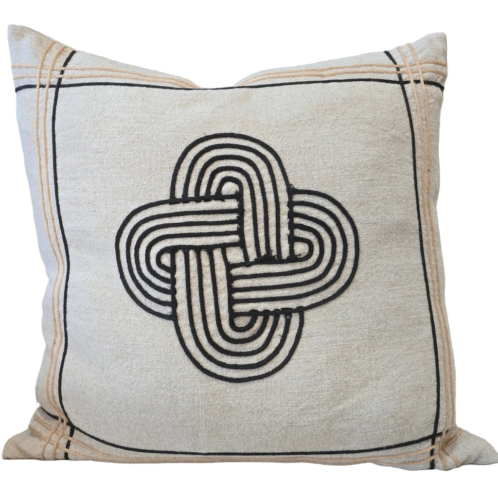 Decorative pillow with a knot pattern on a couch