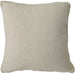 Outdoor Textured beige pillow on a light gray sofa next to a wooden bookshelf.