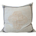 Decorative pillow with a Celtic knot design on a couch
