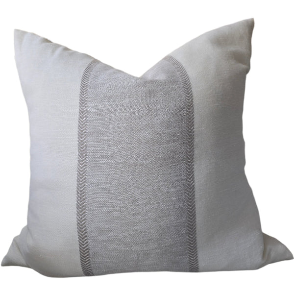 Gray pillow on a sofa with a blurred background