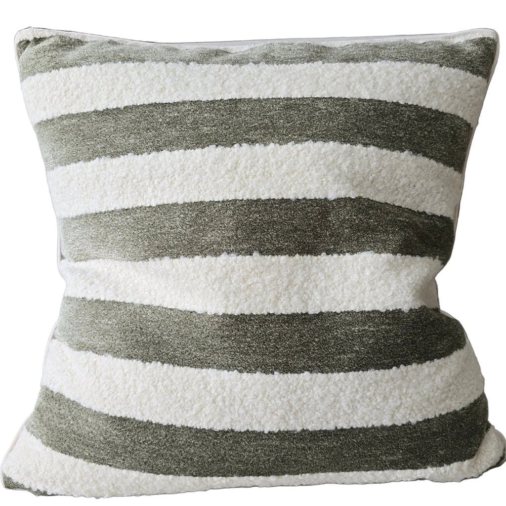 Striped pillow with green and white stripes on a couch