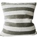 Striped pillow with green and white stripes on a couch