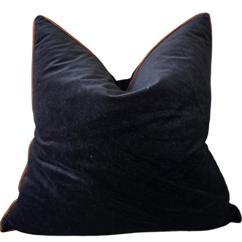 Black pillow on a beige sofa