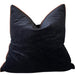 Black pillow on a beige sofa