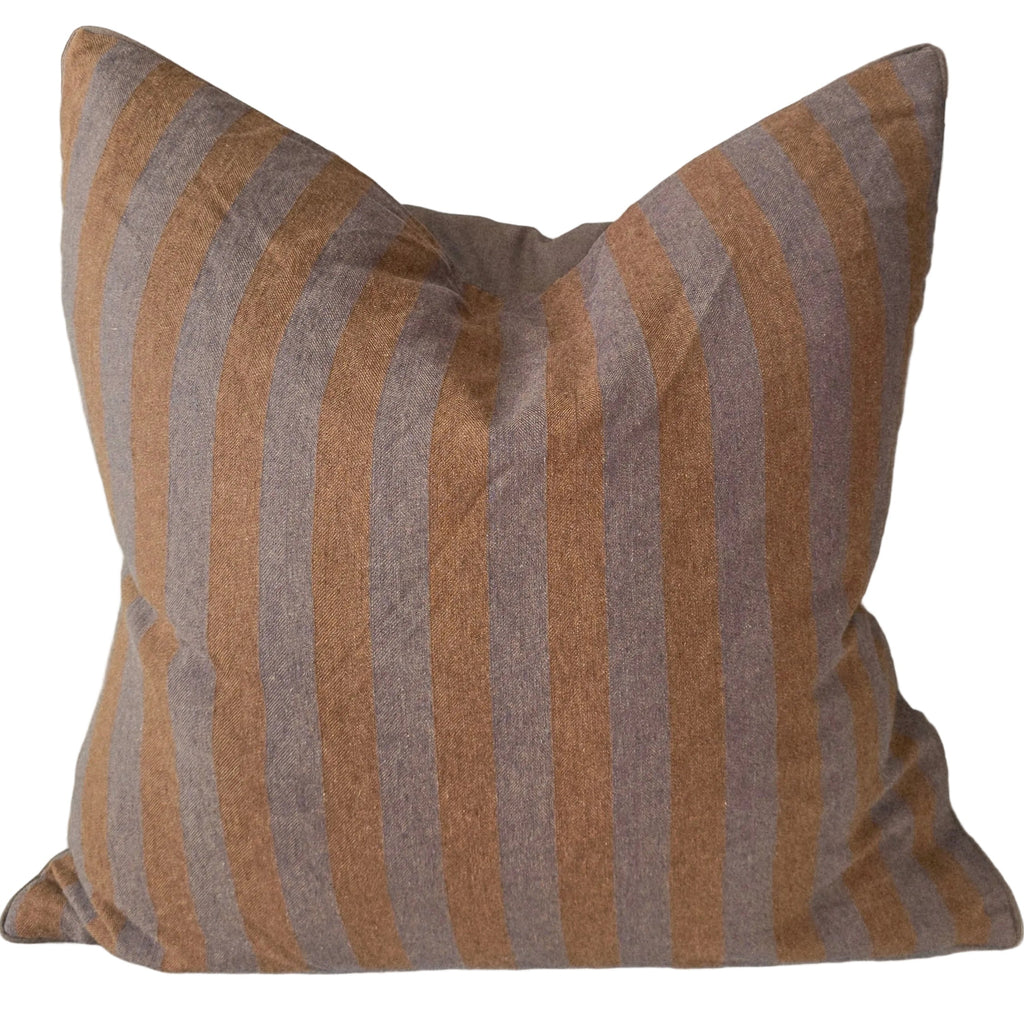 Striped pillow on a sofa with a neutral color palette