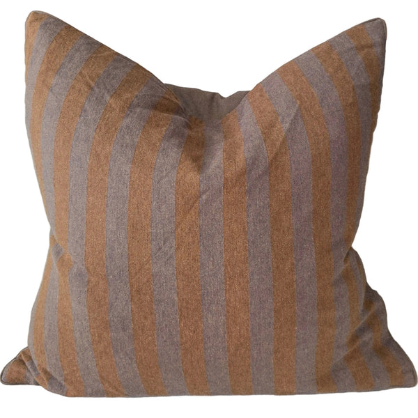 Striped pillow on a sofa with a neutral color palette