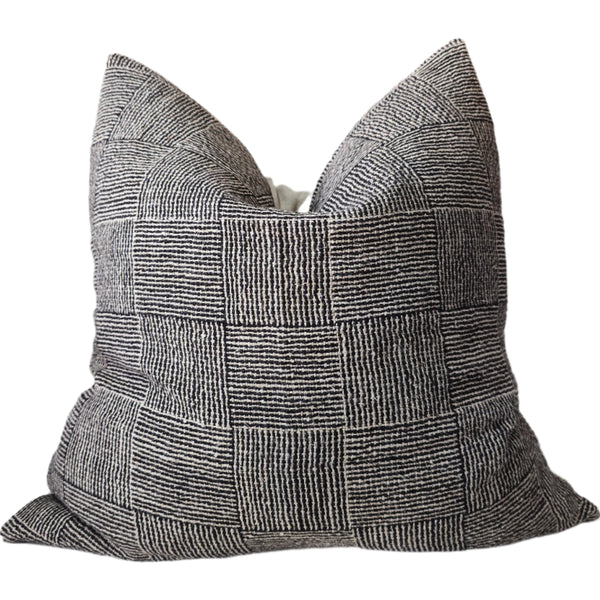 Textured black and white pillow on a white background