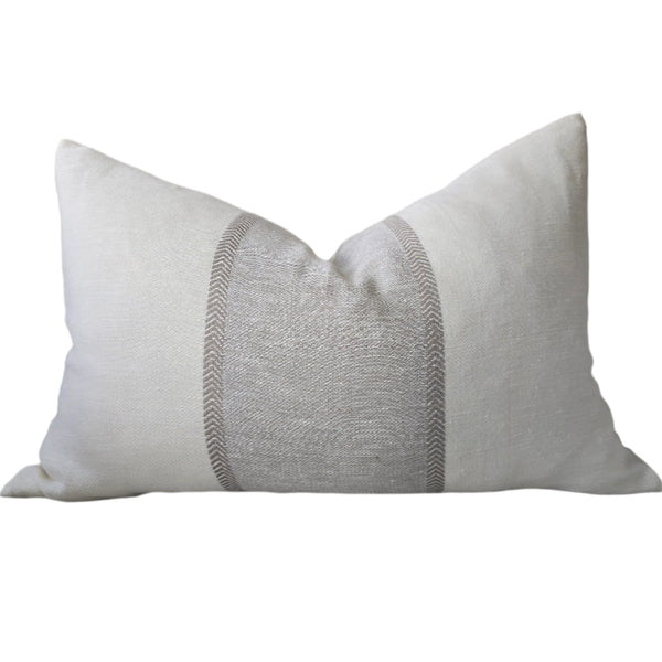 Gray pillow with decorative stitching on a gray sofa