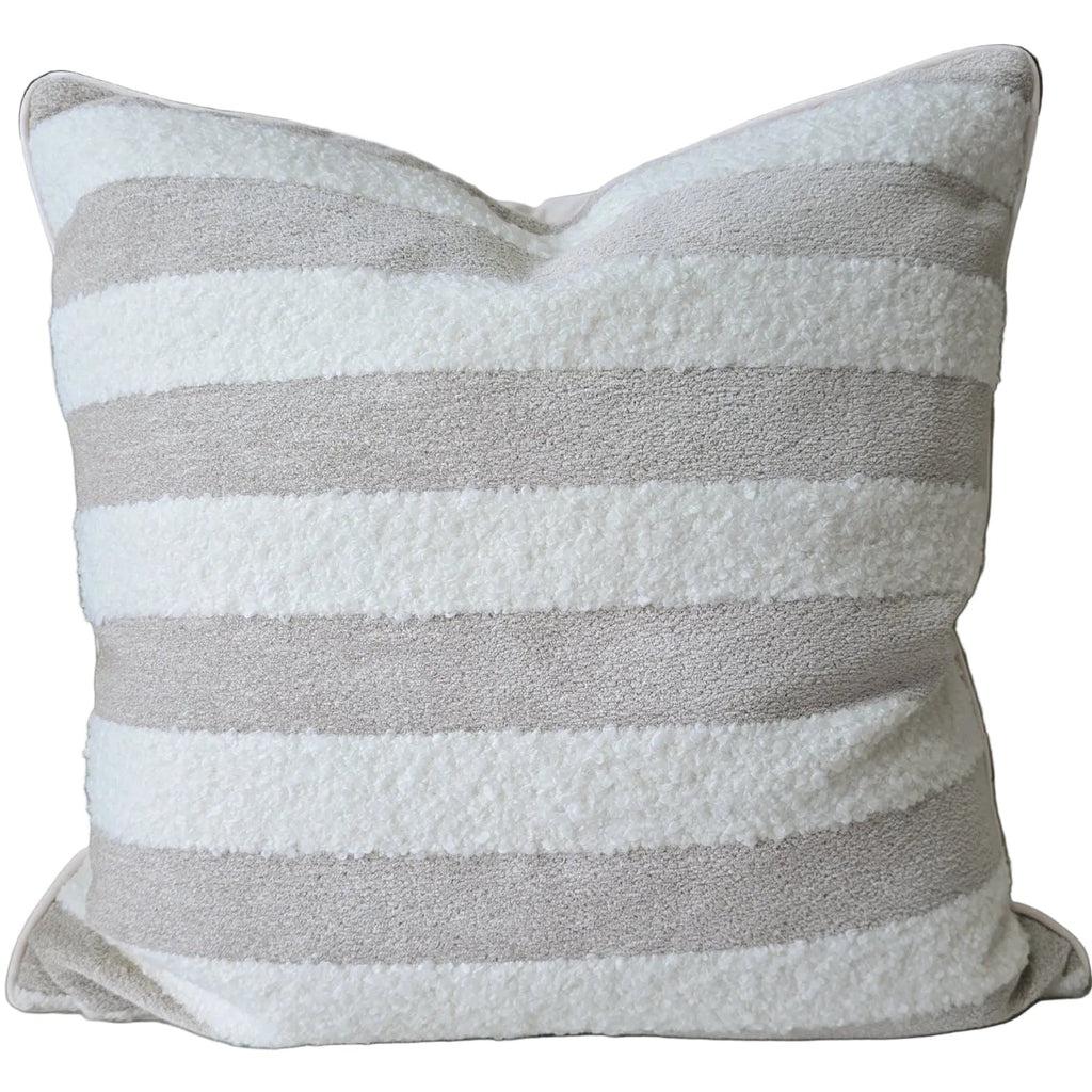 Striped pillow on a sofa with a neutral background