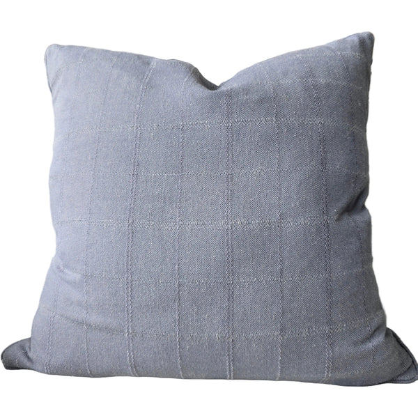 Gray pillow on a couch with a colorful abstract painting in the background