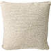 Outdoor Textured beige pillow on a sofa with a decorative lamp and rug in the background