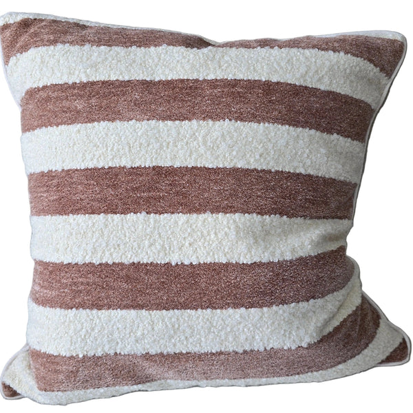 Striped pillow on a gray sofa with wooden armrests.