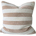 Striped pillow on a sofa with a wooden table in the background