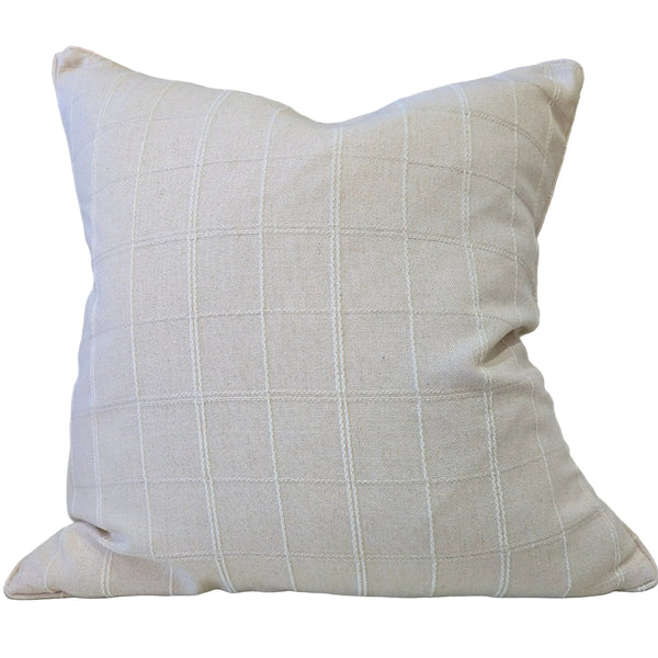 Beige pillow with grid pattern on a beige couch