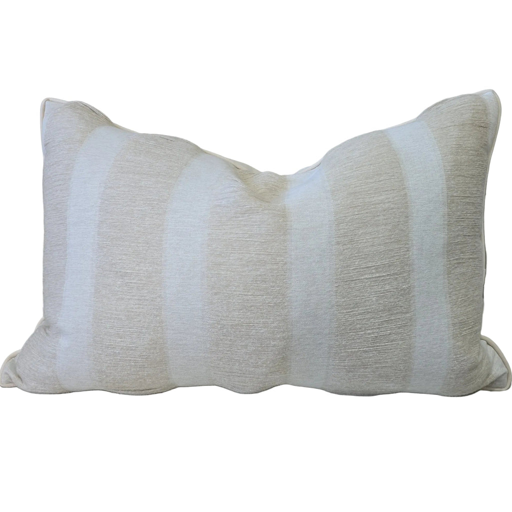 Beige pillow with white stripes on a beige sofa