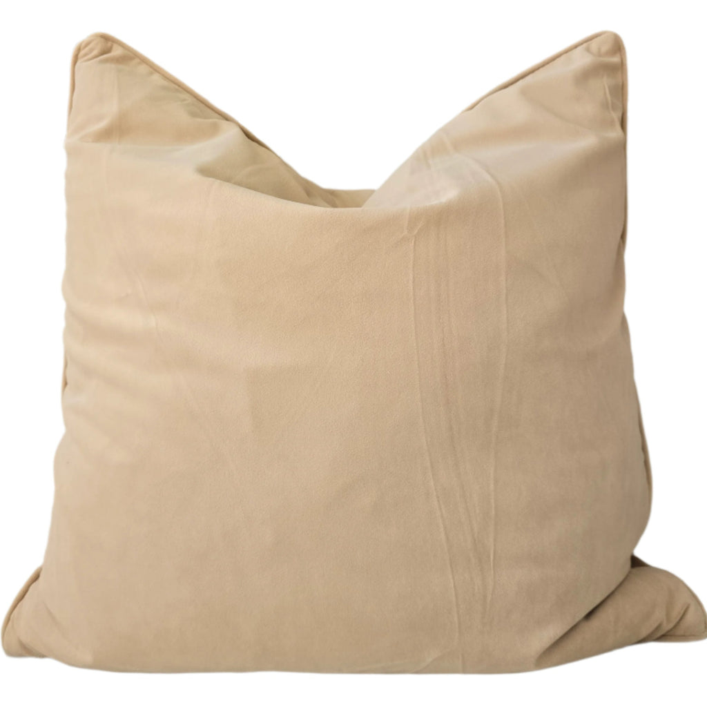 Beige pillow on a sofa with a neutral background