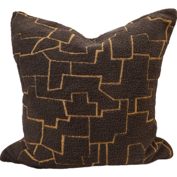 Decorative pillow with geometric pattern on a neutral background